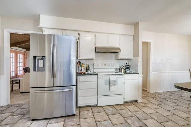 a kitchen with stainless steel appliances a refrigerator sink and cabinets