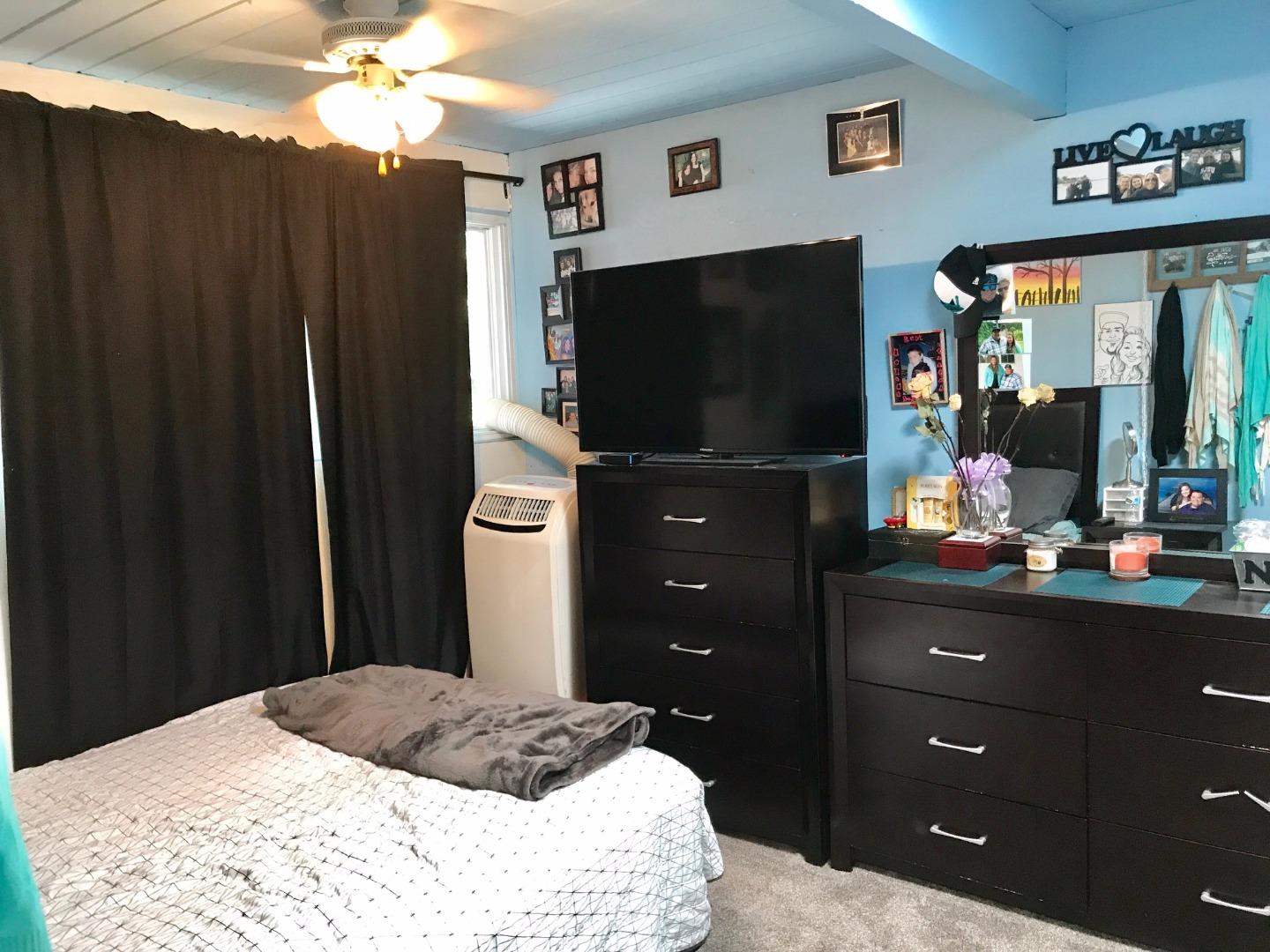 6087 Bollinger Road Cupertino, CA 95014 - Photo 12 of 20 a bedroom with a bed and a flat screen tv