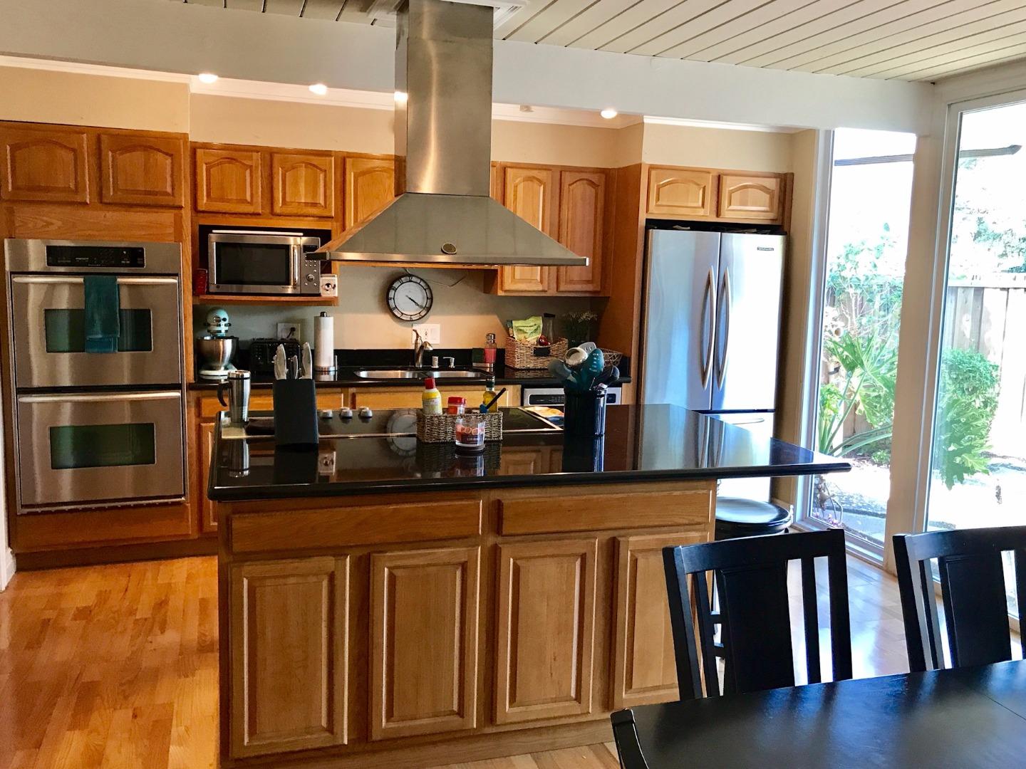 6087 Bollinger Road Cupertino, CA 95014 - Photo 2 of 20 a kitchen with wooden floor