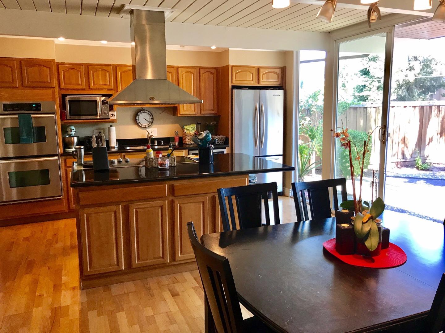 6087 Bollinger Road Cupertino, CA 95014 - Photo 3 of 20 a dining table with chairs and a table