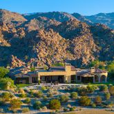 a view of a swimming pool with a table chairs and a yard