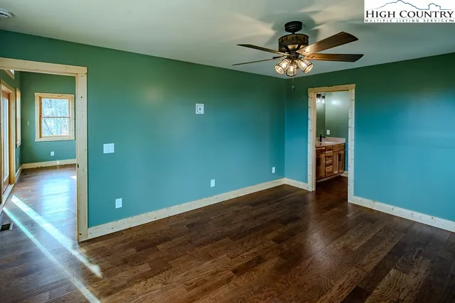 wooden floor in an empty room with a mirror