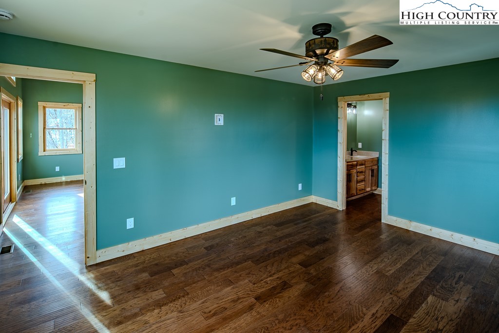 111 Village Cluster Road Beech Mountain, NC 28604 - Photo 13 of 27 wooden floor in an empty room with a mirror