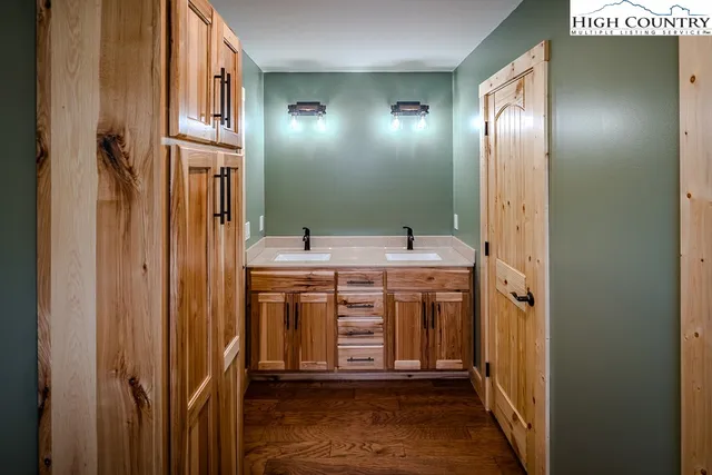 a bathroom with a granite countertop sink toilet and mirror