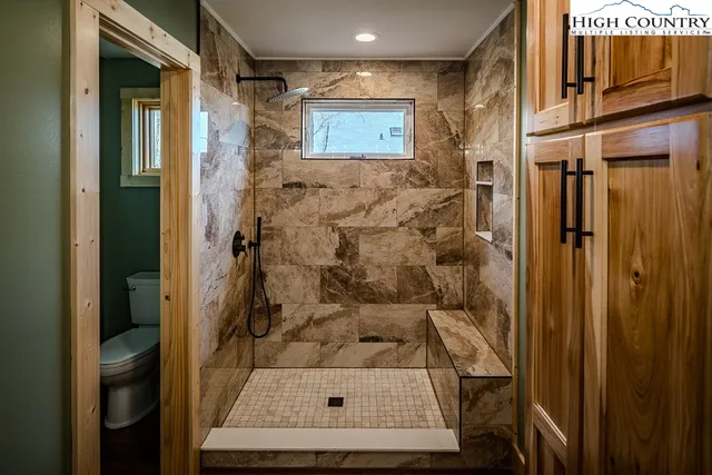 a view of a room with a fan and a window