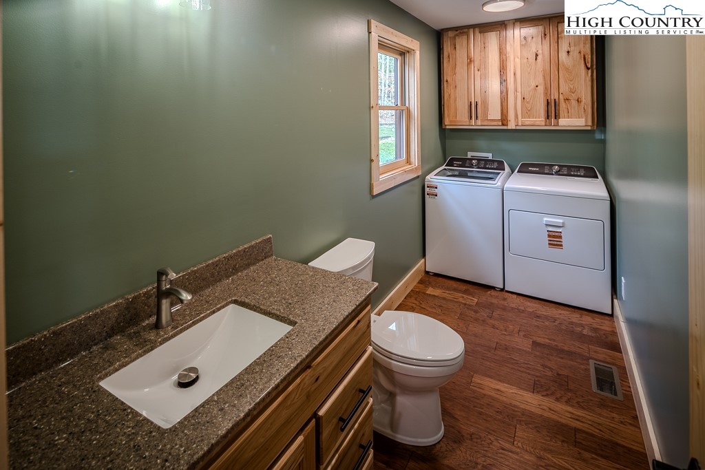 111 Village Cluster Road Beech Mountain, NC 28604 - Photo 16 of 27 a bathroom with a granite countertop sink toilet and mirror