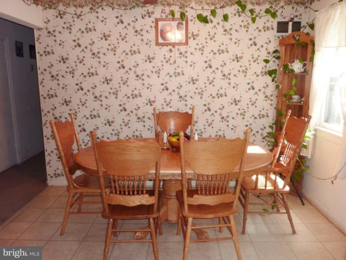 4117 Anderson Road Triangle, VA 22172 - Photo 19 of 30 a view of a dining room with furniture and wooden floor