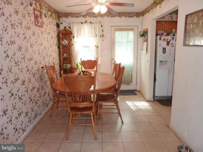 4117 Anderson Road Triangle, VA 22172 - Photo 20 of 30 a view of a dining room with furniture and chandelier fan