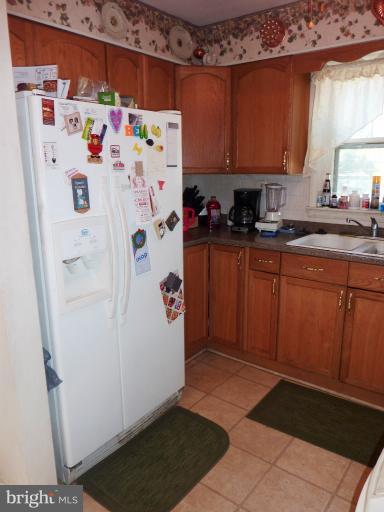 4117 Anderson Road Triangle, VA 22172 - Photo 21 of 30 a white refrigerator freezer sitting inside of a kitchen