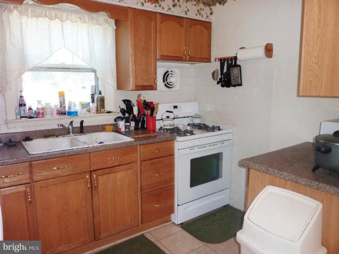 4117 Anderson Road Triangle, VA 22172 - Photo 22 of 30 a kitchen with a sink cabinets and a stove
