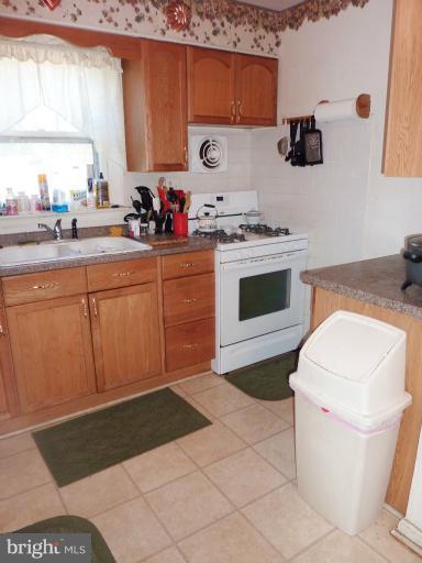 4117 Anderson Road Triangle, VA 22172 - Photo 24 of 30 a kitchen with a stove sink and a microwave