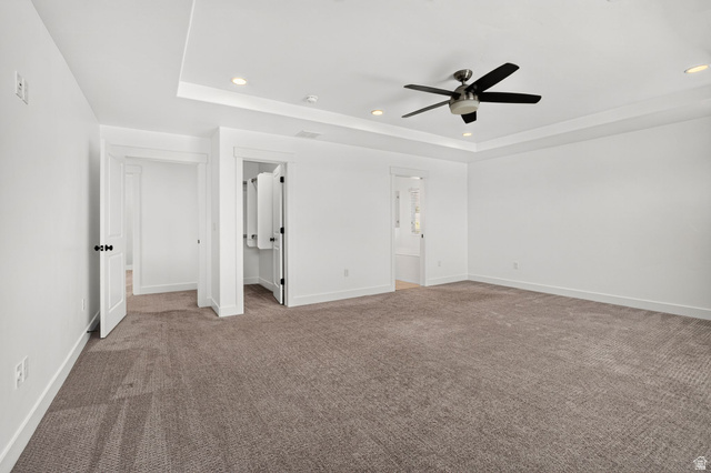 6536 West Muirfield Road Highland, UT 84003 - Photo 27 of 48 Spacious room featuring neutral carpeting, white walls, a tray ceiling with recessed lighting, and a ceiling fan
