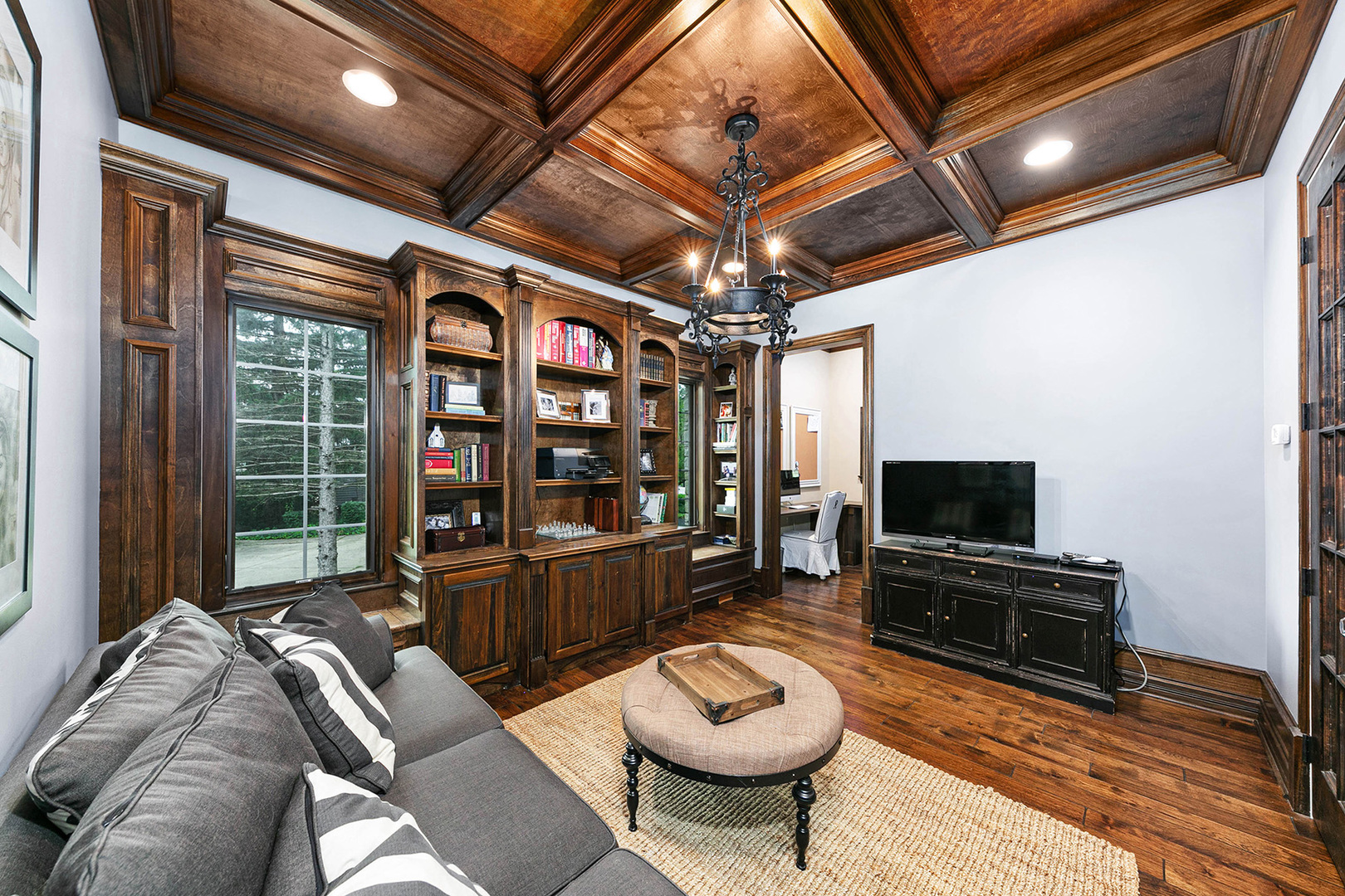 900 East Hillside Road Naperville, IL 60540 - Photo 28 of 73 a living room with furniture a flat screen tv and a floor to ceiling window