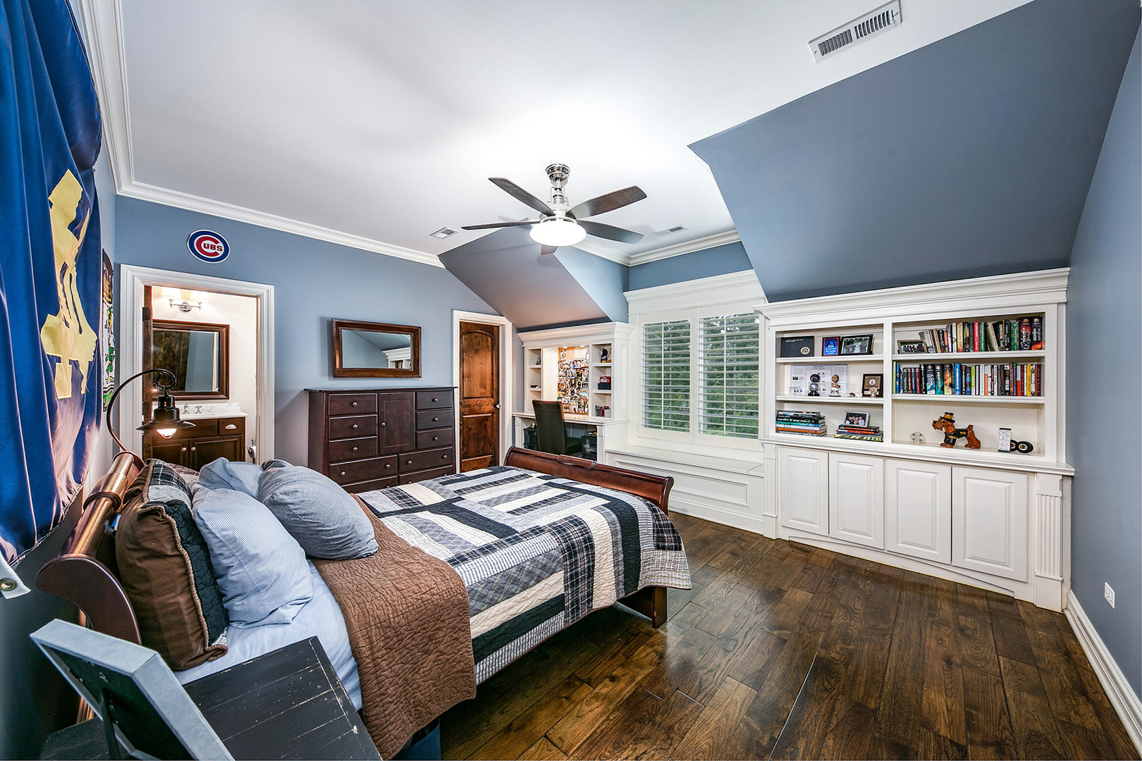 900 East Hillside Road Naperville, IL 60540 - Photo 49 of 73 a spacious bedroom with a large bed a chandelier and windows