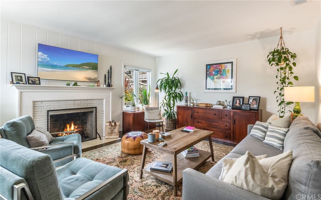 316 7th Street Manhattan Beach, CA 90266 - Photo 11 of 34 a living room with furniture a fireplace and a chandelier