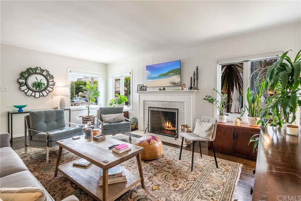 316 7th Street Manhattan Beach, CA 90266 - Photo 13 of 34 a living room with furniture a rug and a fireplace