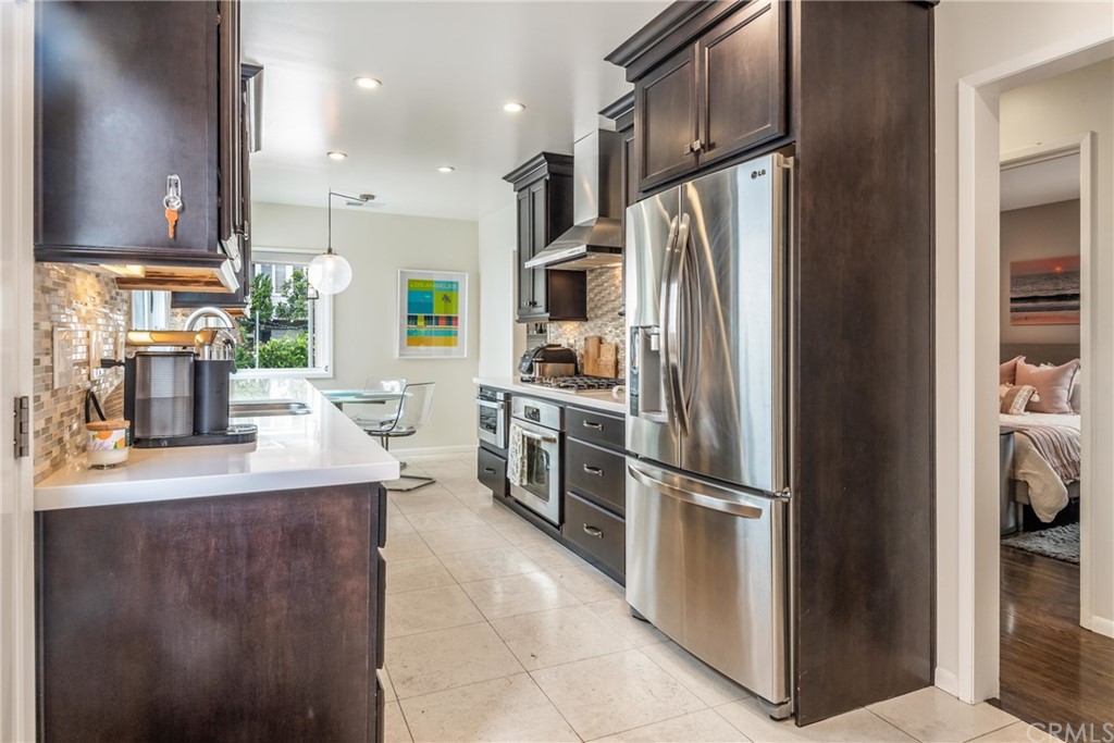 316 7th Street Manhattan Beach, CA 90266 - Photo 14 of 34 a kitchen with kitchen island a counter top space cabinets and stainless steel appliances