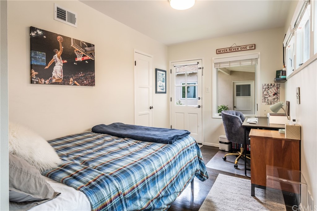 316 7th Street Manhattan Beach, CA 90266 - Photo 23 of 34 a bedroom with a bed and wooden floor