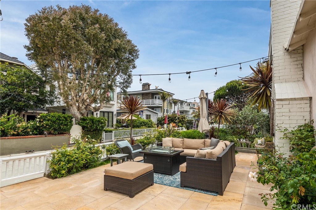 316 7th Street Manhattan Beach, CA 90266 - Photo 7 of 34 a view of a patio with couches and a fire pit and a yard