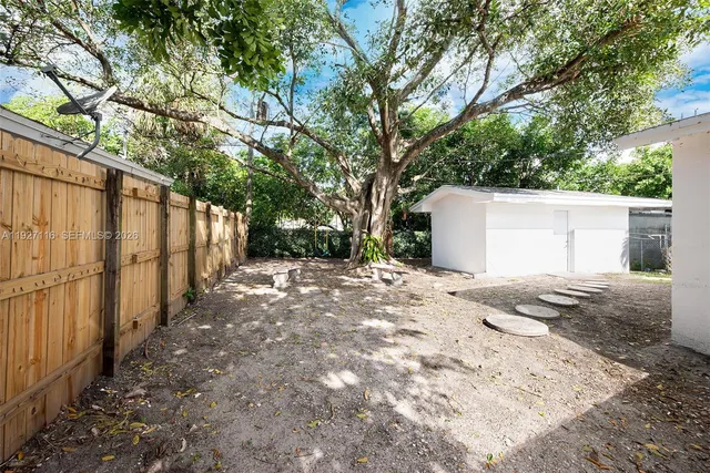 a view of a backyard of the house