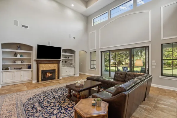 a bathroom with a granite countertop double vanity sink and mirror