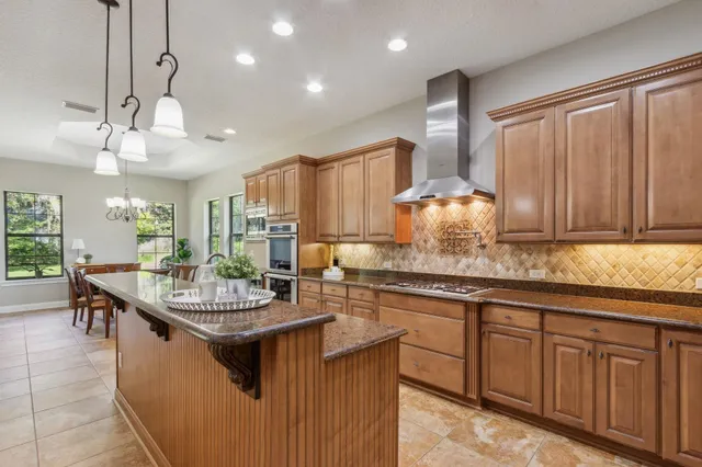 a bathroom with a granite countertop sink a large mirror and vanity