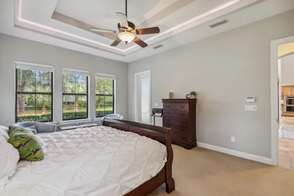 a bedroom with a bed and a dresser with mirror