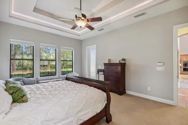 a bedroom with a bed and a dresser with mirror