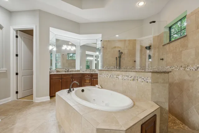 a view of a livingroom kitchen and hall with wooden floor