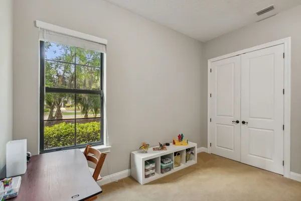 a view of a livingroom with workspace and a window