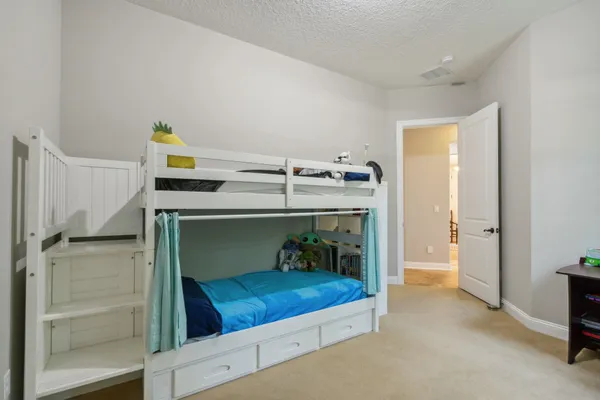 a bedroom with a bed and a chandelier