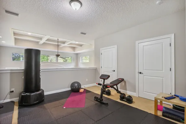 a living room with furniture and floor to ceiling windows