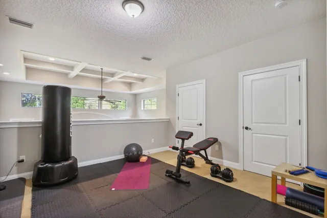 a living room with furniture and floor to ceiling windows