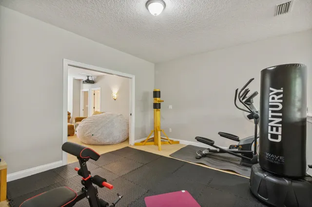 a patio with a table and chairs under an umbrella