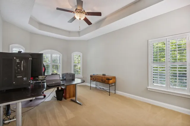 a front view of a house with swimming pool having outdoor seating