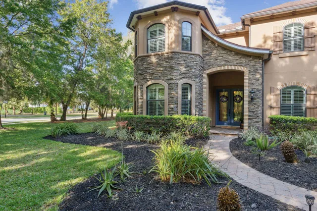 a front view of a house with a garden