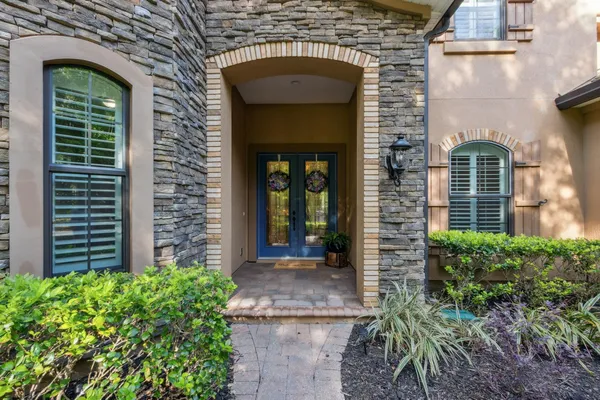 a view of a dining room with furniture and chandelier