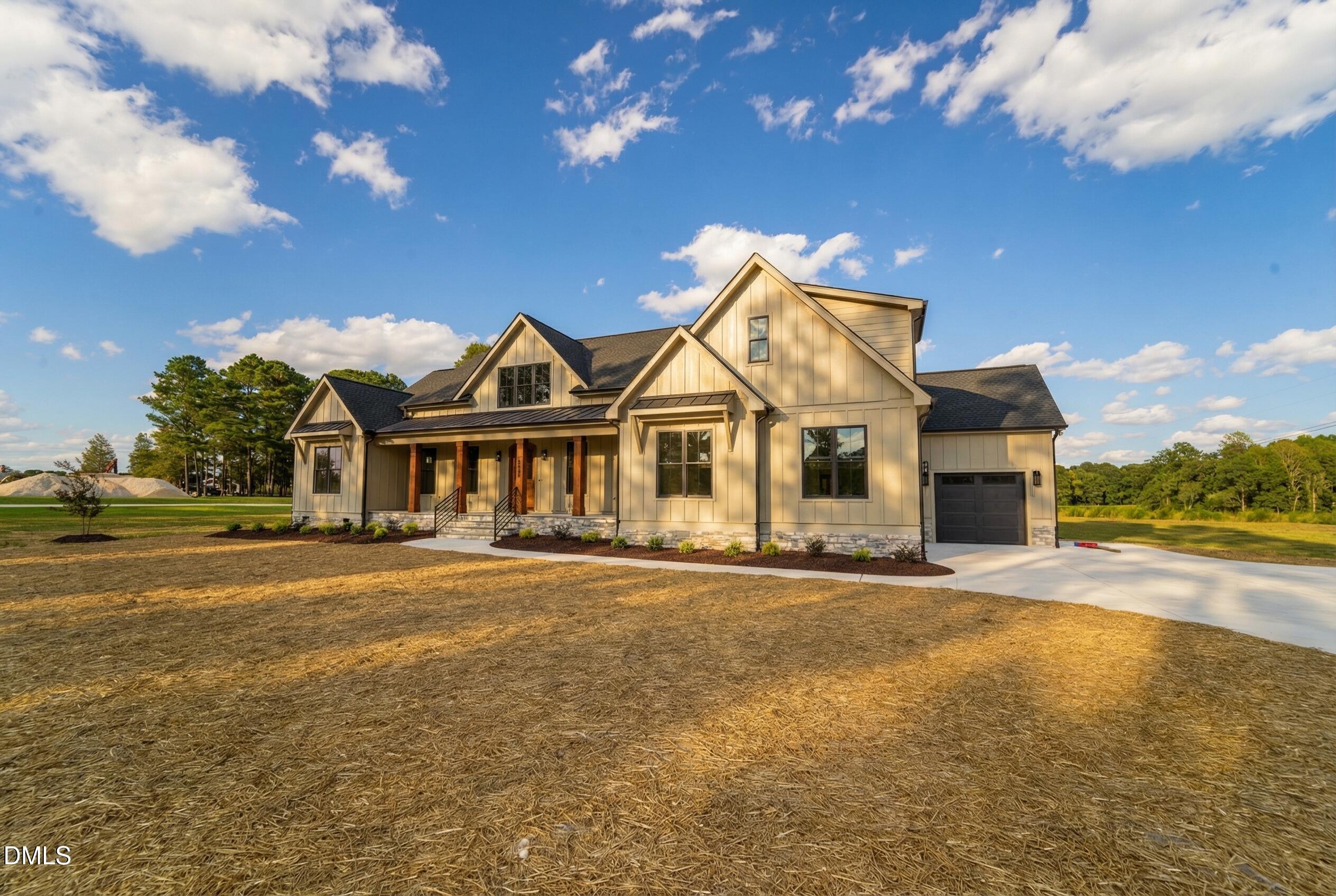 5008 Hopkins Chapel Road Zebulon, NC 27597 - Photo 1 of 32 a front view of a house with a yard and lake view