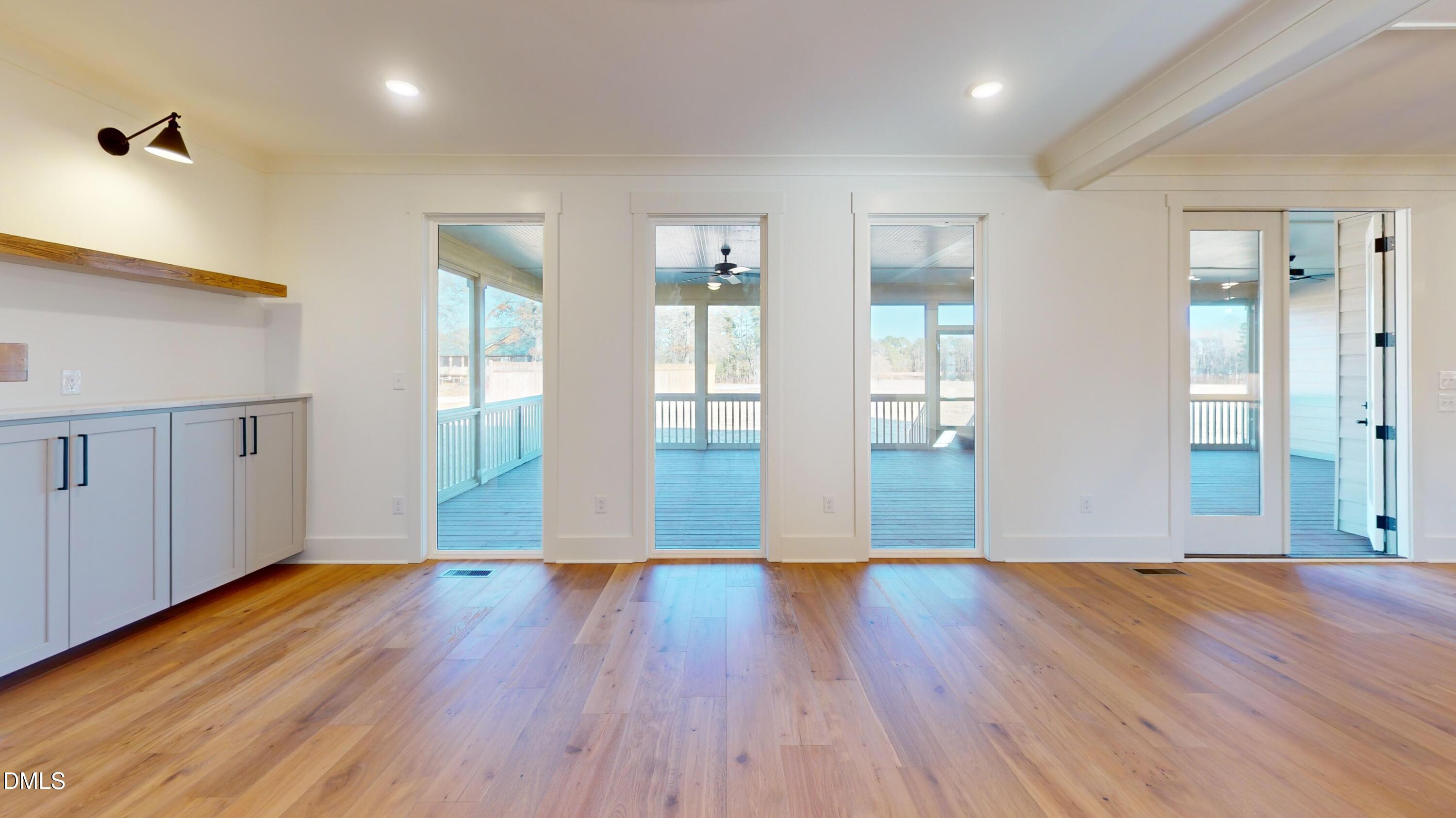 5008 Hopkins Chapel Road Zebulon, NC 27597 - Photo 17 of 32 a view of an empty room with wooden floor and a window