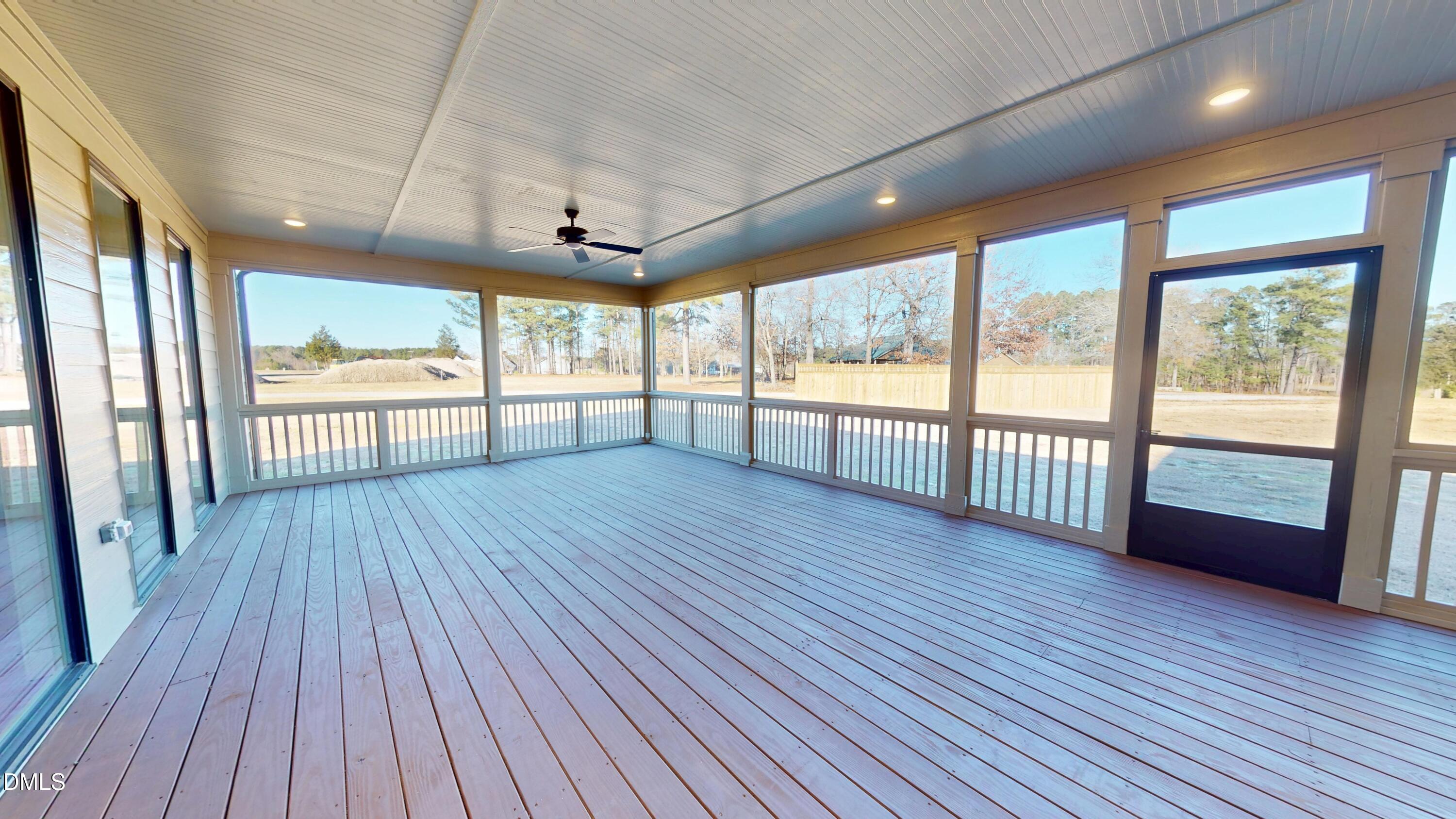 5008 Hopkins Chapel Road Zebulon, NC 27597 - Photo 22 of 32 an empty room with wooden floor and balcony