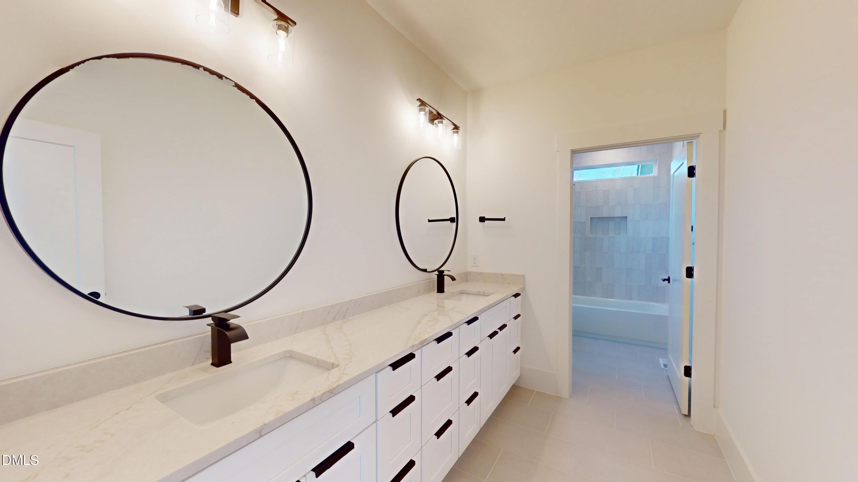 5008 Hopkins Chapel Road Zebulon, NC 27597 - Photo 24 of 32 a bathroom with a sink and a mirror