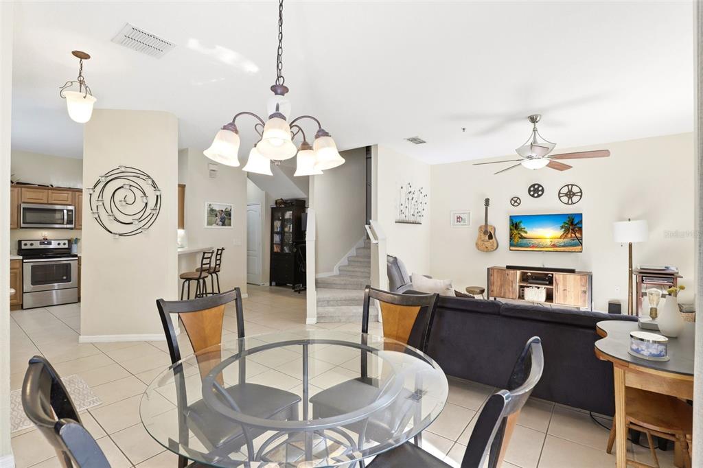 6458 South Goldenrod Road, Unit 29B Orlando, FL 32822 - Photo 11 of 40 a view of a dining room with furniture and a chandelier
