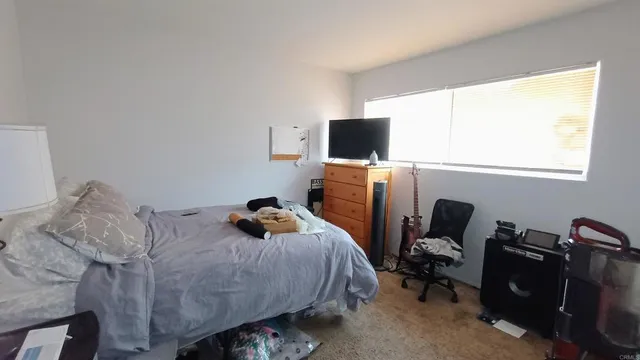 a bedroom with a bed and a flat screen tv