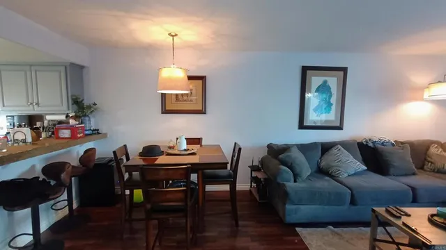 a living room with furniture a window and a dining table