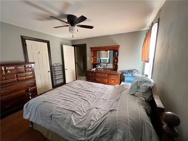 a bedroom with a bed and dresser with mirror
