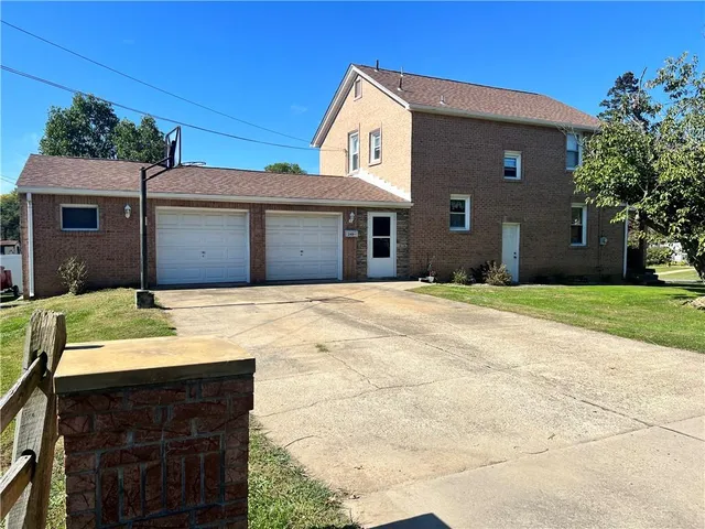 a front view of a house with yard