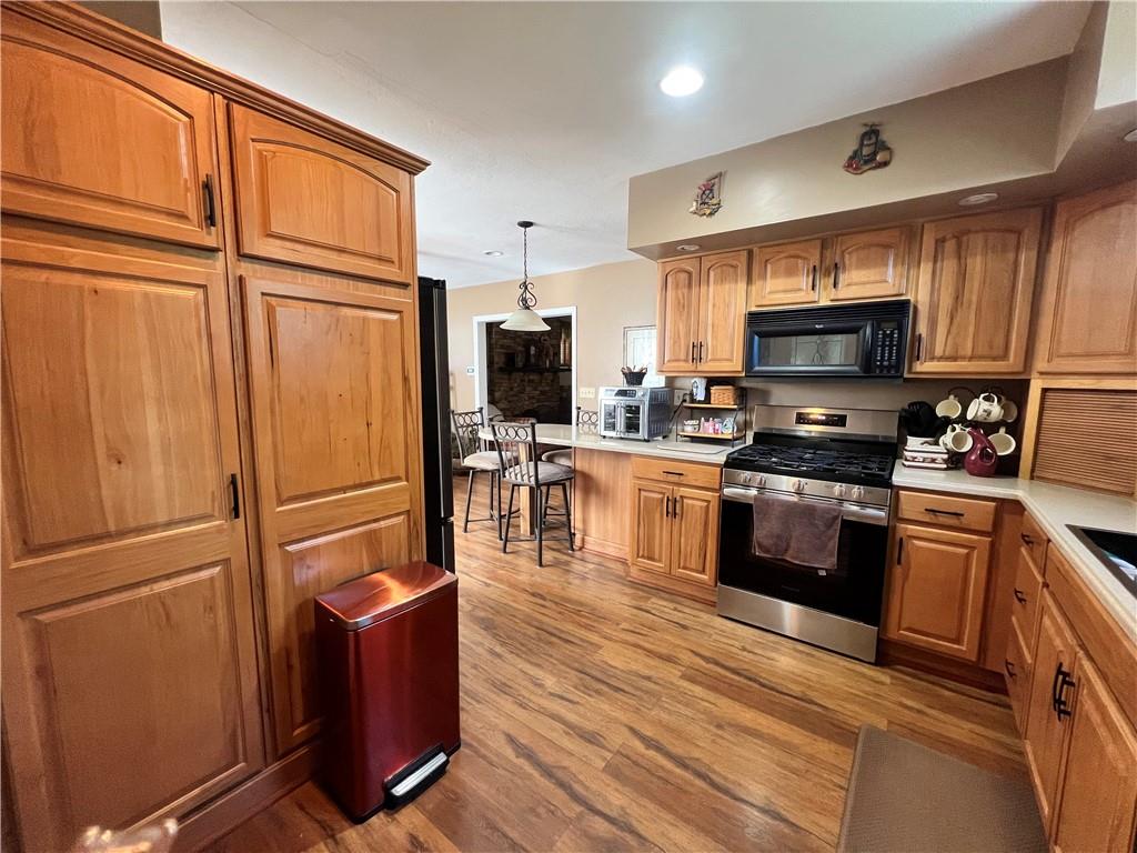 248 Ruth Street Pittsburgh, PA 15211 - Photo 8 of 24 a kitchen with stainless steel appliances granite countertop a refrigerator stove and microwave
