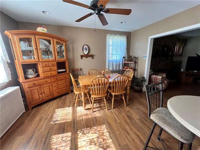 a dining room with furniture window and wooden floor
