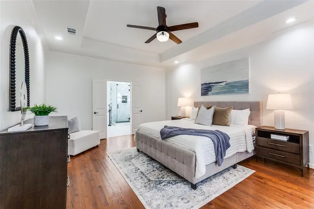 a bedroom with bed and a chandelier