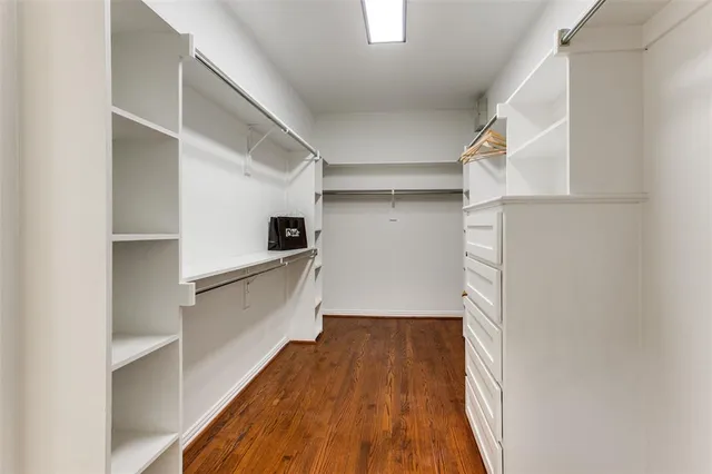 a view of walk in closet with empty racks